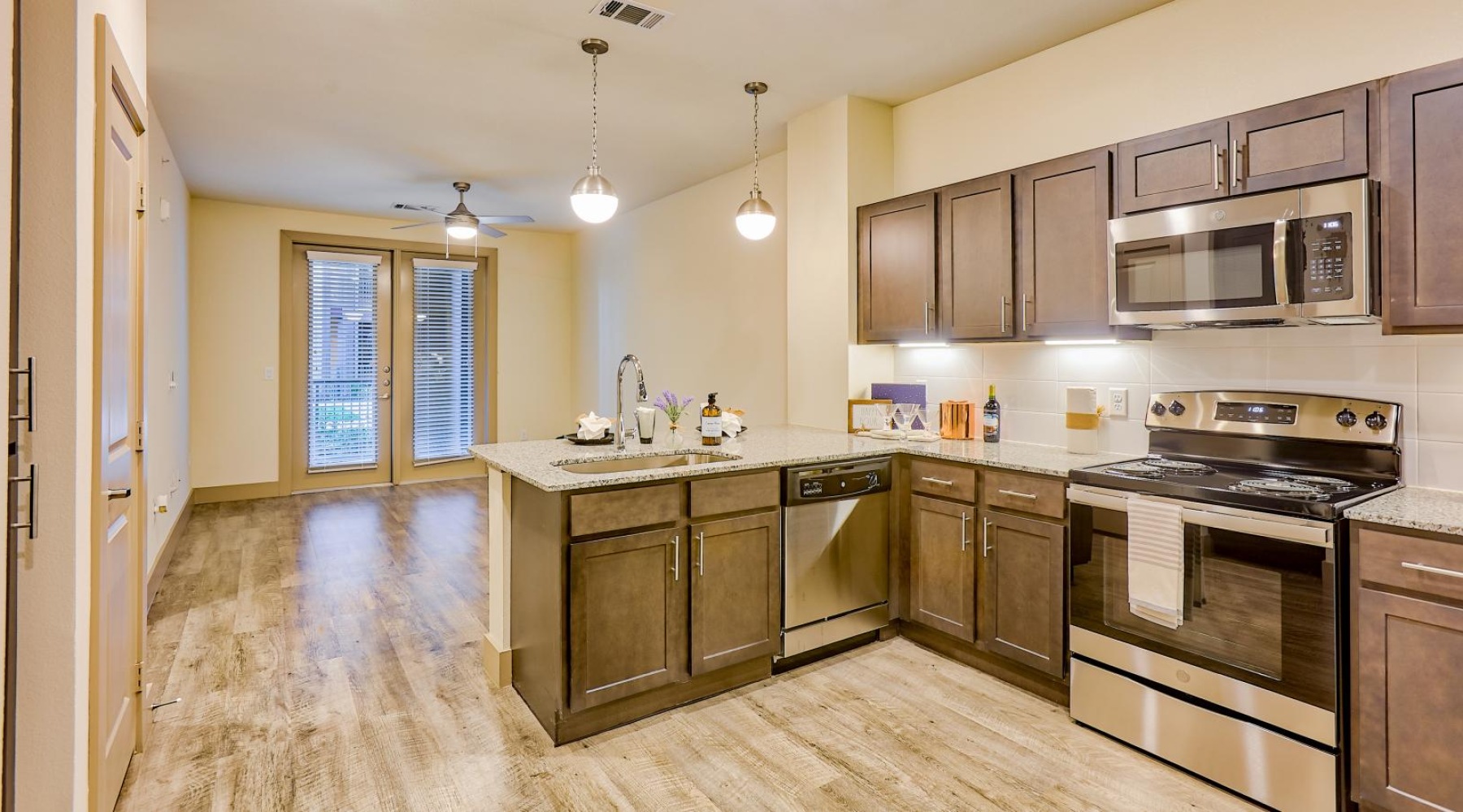 a kitchen with wooden cabinets and stainless steel appliances