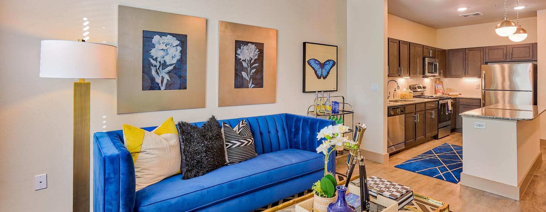 a living room with a blue couch and a coffeetable