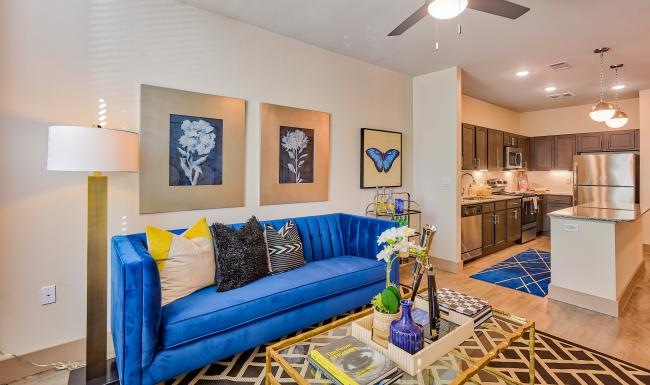 a living room with a blue couch and a coffeetable